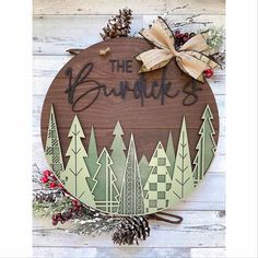 "This custom wood round cutout is made from birchwood plywood. Comes in 16\" or 18\" rounds, 1/4 \" thick. Is a great addition to any winter/Christmas decor or would make a great gift. Twine rope is attached to hang the sign. Back comes unfinished. **Words and tree accents are laser cut and placed on top for a 3D effect. No other decor is included except for bow. This is a handmade product and there may be slight variation in wood grain from one order to the next. Please add the last name you wo Winter Door Signs, Winter Door Hangers, Winter Christmas Decor, Farmhouse Door Hanger, Christmas Door Sign, Painted Antlers, Cricut Signs, Glowforge Ideas, Glowforge Projects