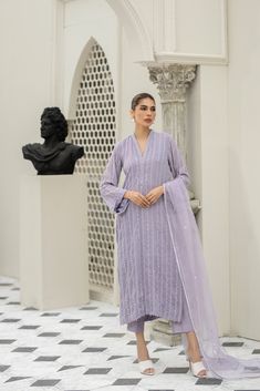 Introducing our stunning Lavender chiffon embroidered shirt hand-worked and embellished with minute mirror work details. Paired with matching raw-silk pants. This elegant dress is adorned with intricate details, featuring beautiful embroidery and embellishments. Elegant Purple Chanderi Palazzo Set, Elegant Purple Palazzo Set With Resham Embroidery, Elegant Purple Sharara With Chikankari Embroidery, Elegant Purple Long Sleeve Palazzo Set, Elegant Long Sleeve Purple Palazzo Set, Elegant Purple Kurta With Mirror Work, Elegant Purple Organza Salwar Kameez, Elegant Purple Sets With Mirror Work, Elegant Purple Salwar Kameez With Chikankari Embroidery