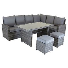 an outdoor patio furniture set with grey cushions and white square table, stools and footstools