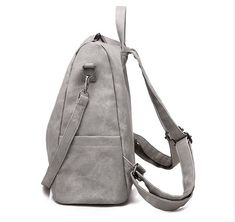 Convertible backpack lets your switch from a shoulder bag to a backpack with the included strap Specifications: Fully lined Strap included Exterior zipper pockets Exterior bottle pockets Backpack straps are not removable Vegan Leather Backpack, Grey Backpacks, Commuter Bag, Convertible Backpack, Blue Backpack, Leather Texture, Backpack Straps, Backpack Purse, School Backpacks