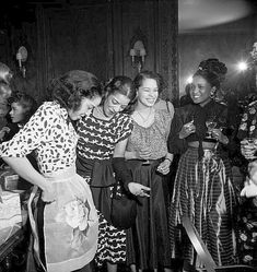 black and white photograph of four women standing together