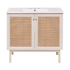 a white cabinet with wicker doors and a sink on the top, against a white background