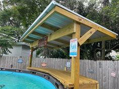 a wooden gazebo next to a swimming pool with a sign on it that says, don't enter