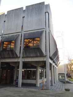 the building is made of concrete and has two stories with windows on each level that are open to let in light