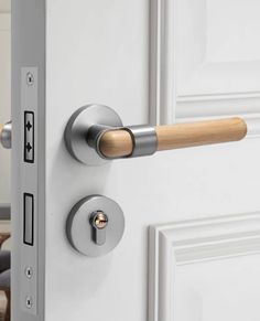 an open door with a wooden handle and knobs on the front part of it