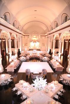 a large ballroom with tables and chairs set up for a formal function in the center