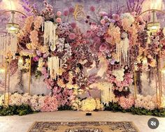 an elaborate floral backdrop with chandeliers and flowers