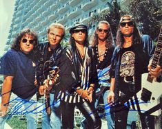 an image of a group of people that are posing for the camera with their guitars