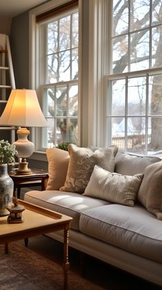 a living room filled with furniture and windows