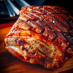 a piece of meat sitting on top of a wooden cutting board