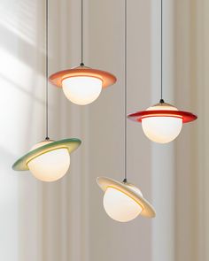 three different colored lights hanging from the ceiling