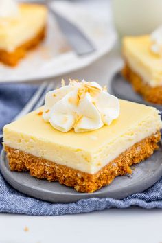 a piece of cheesecake on a plate with a fork and cup in the background