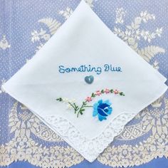 "One of a kind new and unused hand embroidered 'Something Blue' vintage cotton lawn handkerchief circa 1950. This delightful handkerchief is made from 100% white cotton. The handkerchief depicts a machine embroidered blue rose with little white and pink flowers in one corner. Blue roses are often portrayed in literature and art as symbols of love and prosperity. The floral motif is set off with delightful guipure lace at one corner. The other sides of the handkerchief are plain and finished off Blue Embroidered Wedding Handkerchief, Blue Embroidered Handkerchief For Wedding, Blue Embroidered Handkerchiefs For Wedding, Blue Embroidered Handkerchiefs For Gifts, Blue Embroidered Handkerchiefs As Gift, Blue Embroidered Handkerchief As Gift, Blue Cotton Handkerchiefs For Wedding, Vintage Embroidered Wedding Handkerchiefs, Vintage Wedding Handkerchiefs With Machine Embroidery