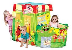 two children playing in a playpen with the sesame street characters on it's sides