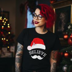 If you are looking for the perfect Believe Christmas Shirt, spooky christmas tee, goth christmas shirt, family christmas tee, dark aesthetic shirt, santa shirt, Believe Shirt then look no further! ►Style Unisex Softstyle Gildan 64000 T-shirt Standard length and fabric non constrictive ► Material  Made of durable cotton fabric and has a double-stitched bottom hem and sleeves.  Solid colors are 100% ring-spun cotton Sport Grey is 90% ring-spun cotton, 10% polyester Dark Heather is 65% polyester, 3 Black Winter Holiday T-shirt, Black Christmas T-shirt As Gift, Black Crew Neck Christmas T-shirt, Black Christmas T-shirt With Short Sleeves, Black Short Sleeve Christmas T-shirt, Black Christmas Graphic Tee, Black Casual T-shirt For Festive Occasions, Casual Black T-shirt For Festive Occasions, New Year Black Crew Neck T-shirt