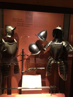 two armor on display in a glass case