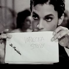 a man holding up a piece of paper with writing on it that says wrecka stow