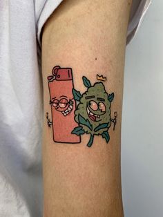 a person with a tattoo on their arm has an image of a cartoon character next to it