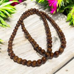 Experience the natural beauty of Hawaiian Koa Wood with our handcrafted beaded necklace or bracelet. Each 8mm bead showcases the unique and popular wood, adding a touch of island-inspired style to your outfit. At 32 inches, this versatile piece can be worn as either a necklace or a double/triple wrapped bracelet. Material: Koa Wood Bead Size: 8mm Size: 32 inches Bracelet or Necklace More about Woods of Hawaii: CLICK HERE Brown Necklaces With 8mm Round Beads, Brown Beaded Necklaces With 8mm Round Beads, Brown Beaded Necklace With 8mm Round Beads, Brown Beaded Necklaces With 8mm Beads, Tropical Jewelry, Tropical Home Decor, Koa Wood, Wood Necklace, A Necklace