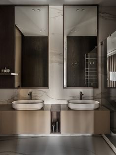 two sinks in a bathroom with mirrors above them