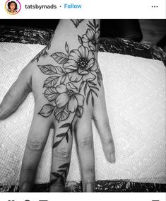 a woman's hand with flowers on it