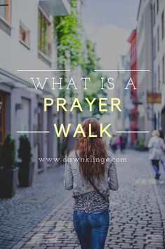 a woman walking down a cobblestone street with the words what is a prayer walk?