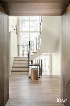 the inside of a house with wood floors and stairs