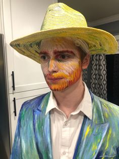 a man wearing a yellow hat and painted face