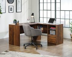 a wooden desk sitting in front of a window