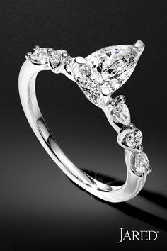 a pear shaped diamond ring with three pears on it