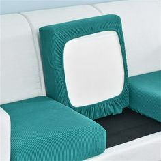 a close up of a couch with a square pillow on it's back end