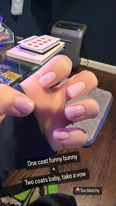 a person with pink nails holding a cell phone