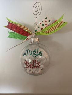 a christmas ornament hanging on the wall with words jingle bells written on it