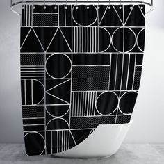 a black and white shower curtain with geometric shapes