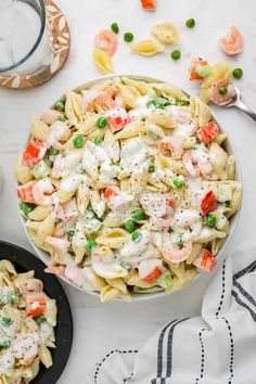 pasta salad with shrimp and peas in a bowl