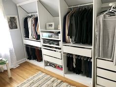 an organized closet with white shelving and drawers