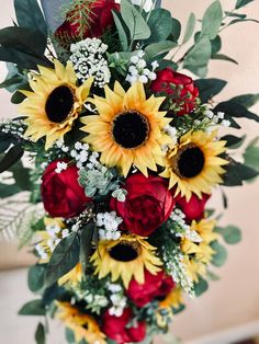 a bouquet of sunflowers and red roses