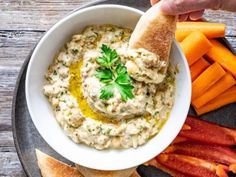 a plate with carrots, bread and dip