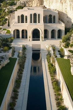 Grand villa with arched windows and long reflective pool. Ever find yourself daydreaming about the perfect house while scrolling through listings way out of your budget? You’re not alone.