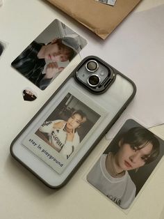 a cell phone case sitting on top of a table next to pictures and other items