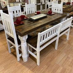 a kitchen table with white chairs around it