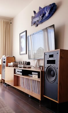 an entertainment center with speakers and stereos in a living room