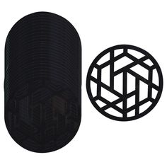 a black object is next to a round object with an interlocked design on it