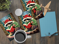 two coasters with a raccoon wearing a red hat and scarf next to a cup of coffee