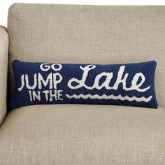 a blue and white pillow that says jump in the lake on it's back