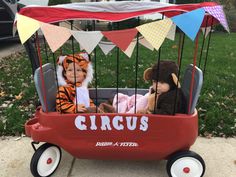 two stuffed animals sitting in a circus wagon