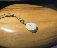 Size 25*6mm  7.8grams  high quality  过眼过灯 一级羊脂白 Comes with certificate Spiritual Round Jade Necklaces, White Jade Jewelry For Meditation, Spiritual White Jade Jewelry, Chinese Jade Necklace Pendants, Chinese Jade Pendant, Safe Lock, Donut Pendant, Hetian Jade, White Jade