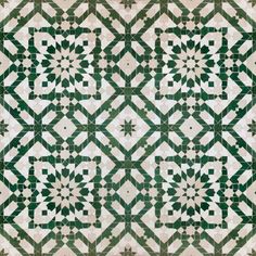 an intricate green and white tile design