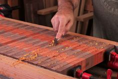 a man is working on a piece of wood