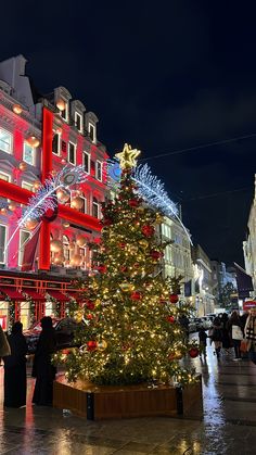 a large christmas tree in the middle of a city